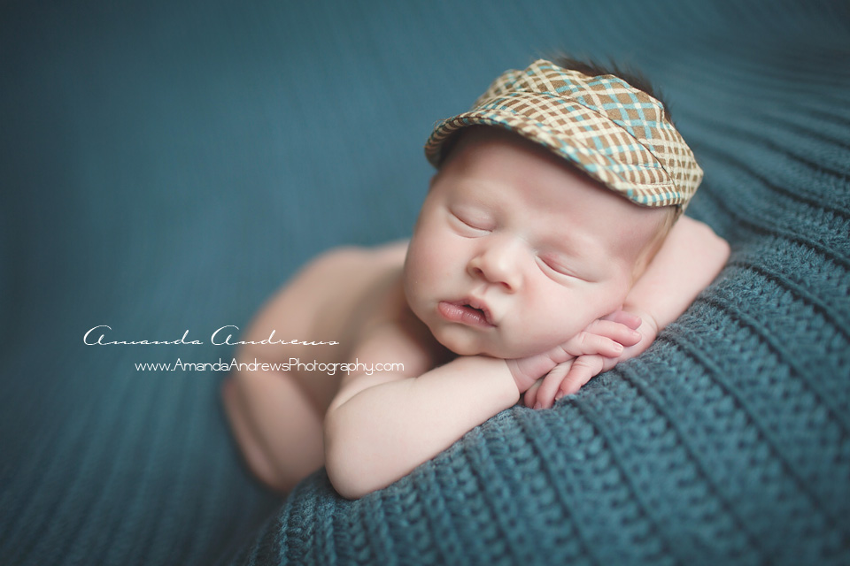 newborn sleeping on blue blanket