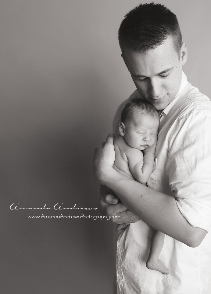 dad holding sleeping newborn