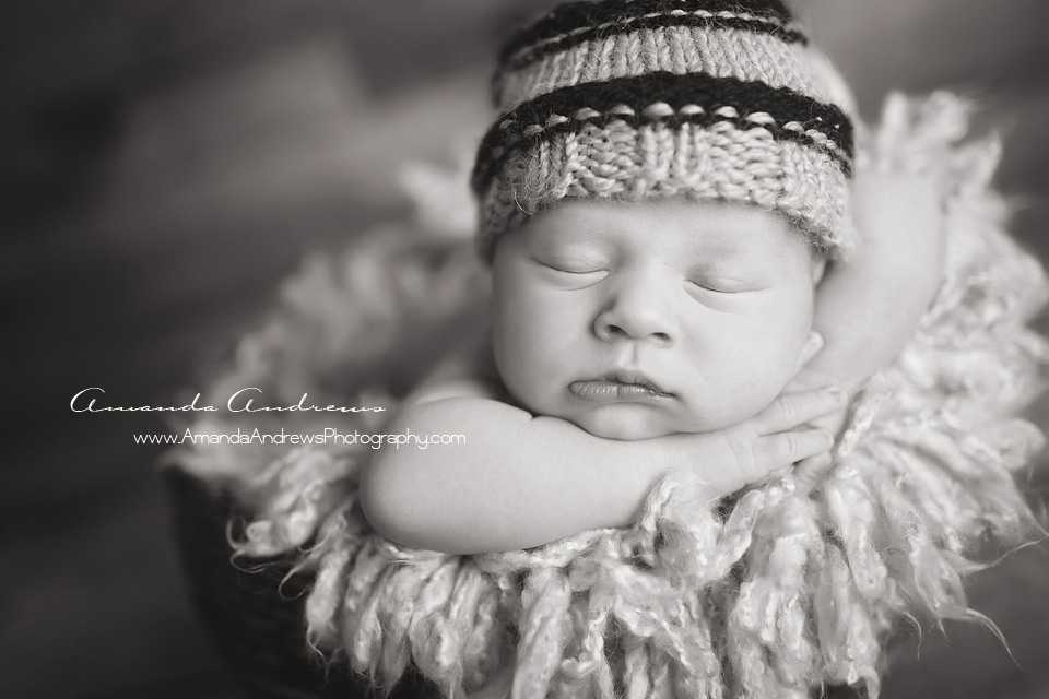 newborn asleep with hat on