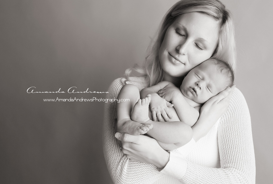mom holding sleeping baby