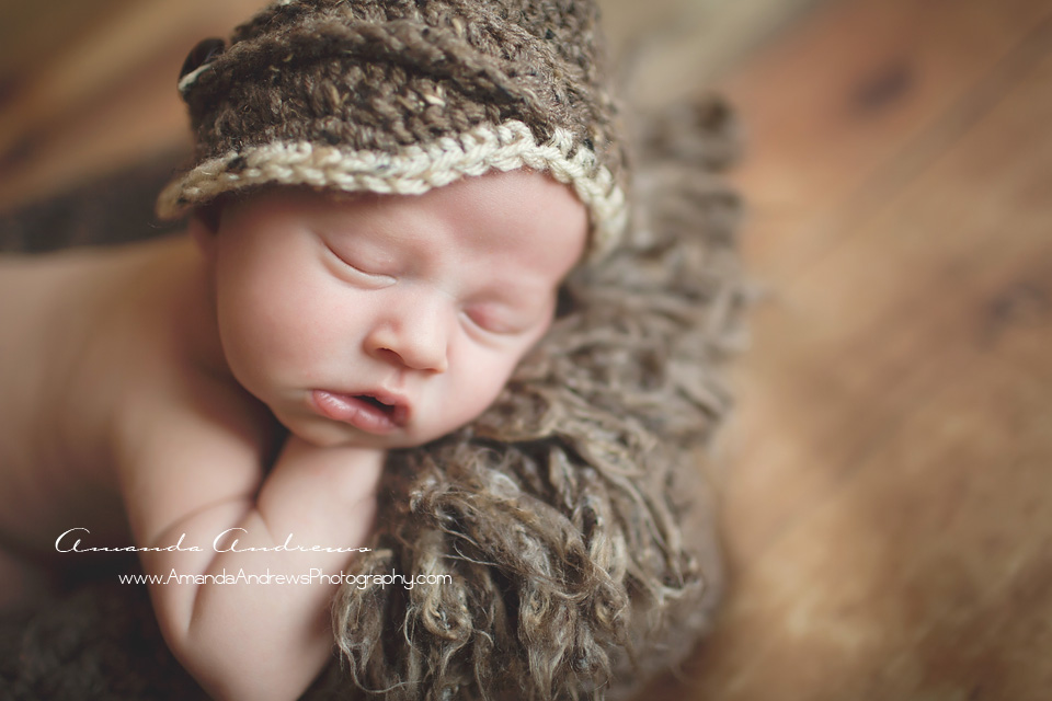 sleeping baby with brown hat on